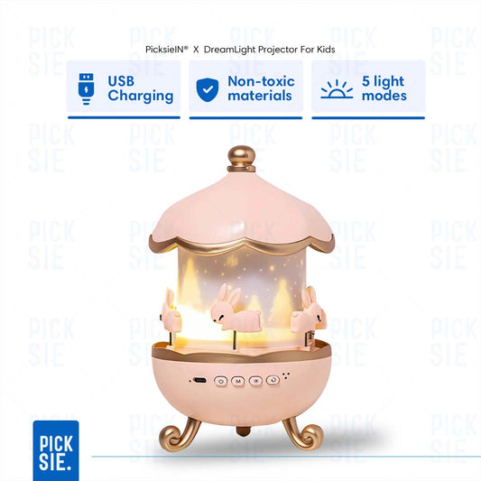Pink and gold carousel-themed projector for kids with USB charging, non-toxic materials, and 5 light modes on a white background.
